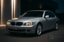 Silver BMW E66 LCI cover shot with angel eyes at night.webp